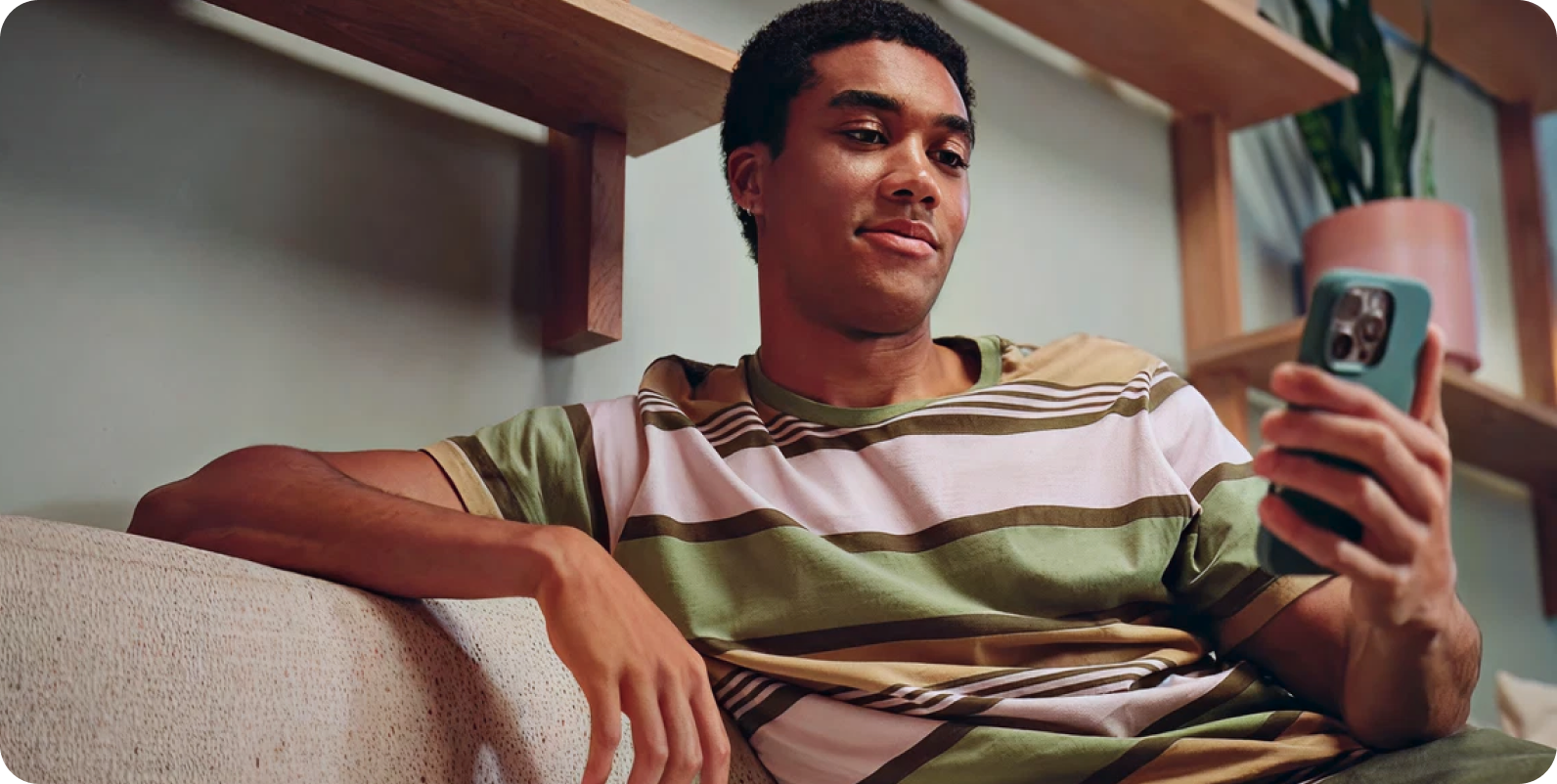 A young man reviewing an onboarding flow on his phone
