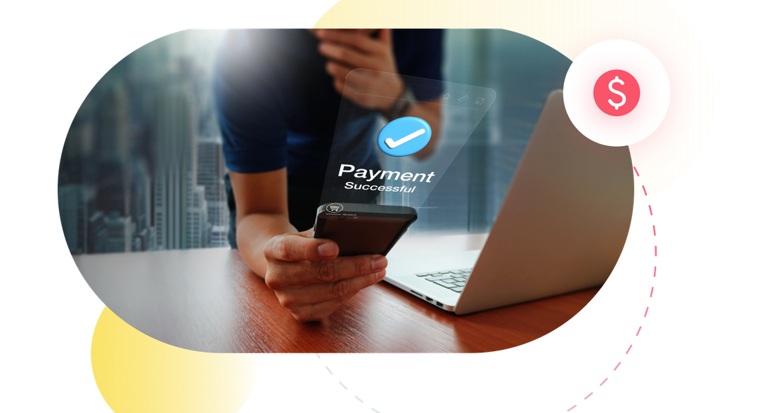 A fintech customer completing a successful payment on a phone next to a laptop