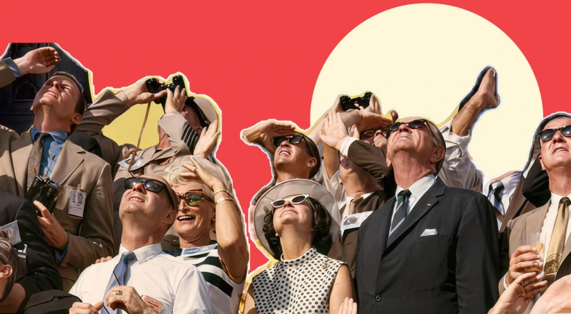 A crowd of people looking upward in anticipation